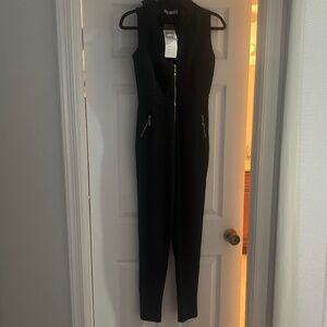 Black jumpsuit with gold zipper